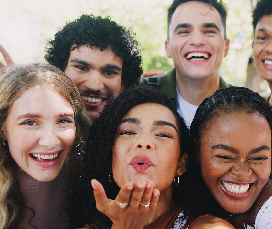 Group of friends gathered together and smiling.